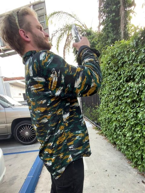 Ryan Levihn-Coon, who built Towed Help, photographing a Los Angeles tow yard's posted signs (2022)